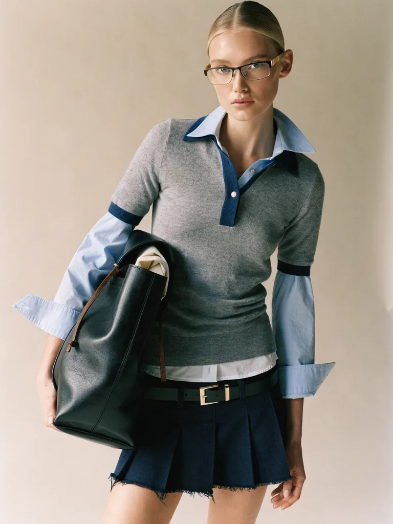 AI-generated fashion image with knit polo and leather tote